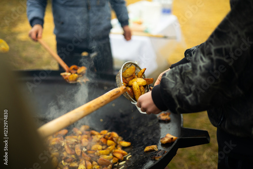 Busy street food fair scene with potato cooking photo