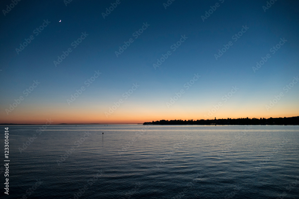 Naklejka premium Sunset at lake Bodensee, Lindau Harbour, in Bavaria, Germany
