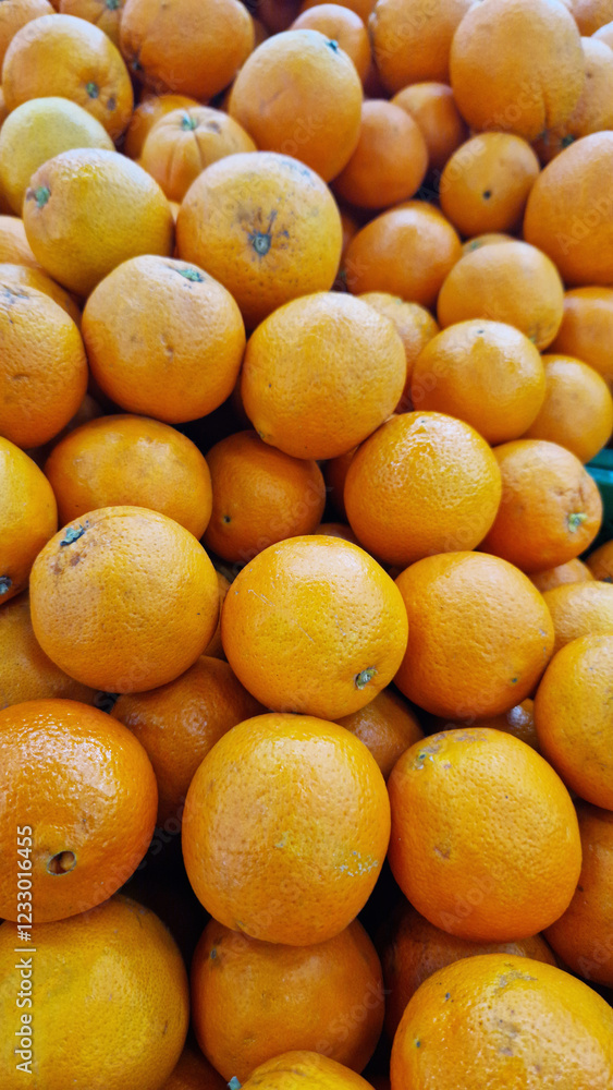 Oranges for sale in a supermarket. Citrus fruits, close-up with selective focus. Oranges in a store. Ripe, juicy, bright orange fruits. Fruits enriched with vitamin C Oranges for sale in a supermarket. Citrus fruits, close-up with selective focus. Oranges in a store. Ripe, juicy, bright orange fruits. Fruits enriched with vitamin C