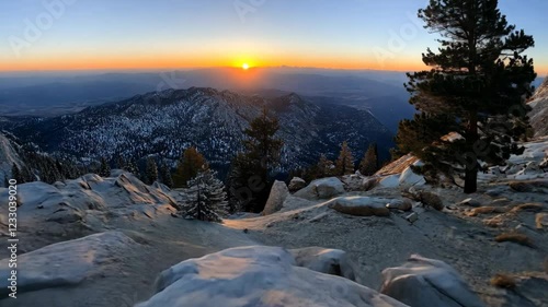 Wallpaper Mural Sunrise over snowy mountain landscape with pine trees and rocky terrain in winter Torontodigital.ca