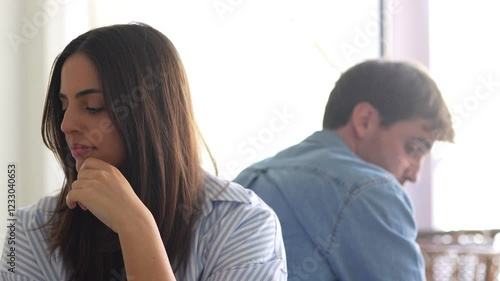 Young man and woman at home using smartphone and laptop, in moments of daily life, connection, emotions, love, conflict, technology and modern lifestyle.