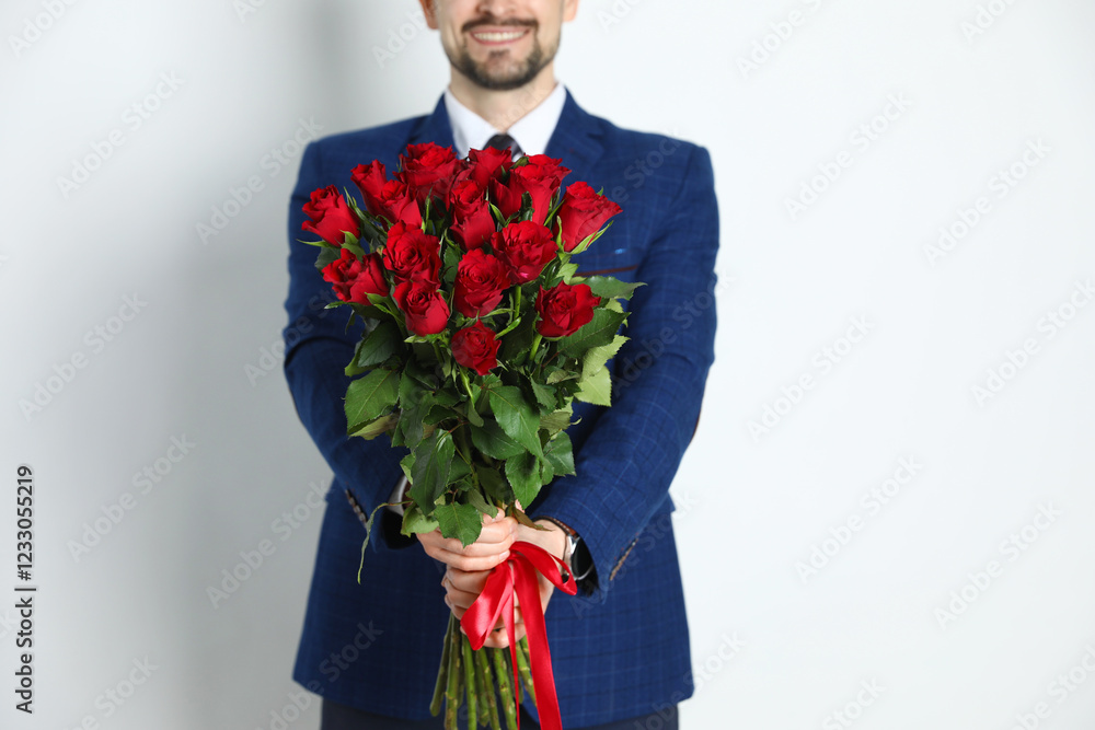 Happy Valentine's Day. Man with bouquet of roses on white background, closeup Happy Valentine's Day. Man with bouquet of roses on white background, closeup