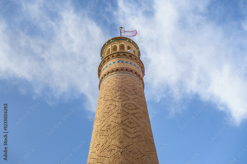 Minaret with brick patterns against a blue sky. This is the only minaret of the main mosque (Jameh mosque) in Kashan, Iran. Built in 1074 Minaret with brick patterns against a blue sky. This is the only minaret of the main mosque (Jameh mosque) in Kashan, Iran. Built in 1074