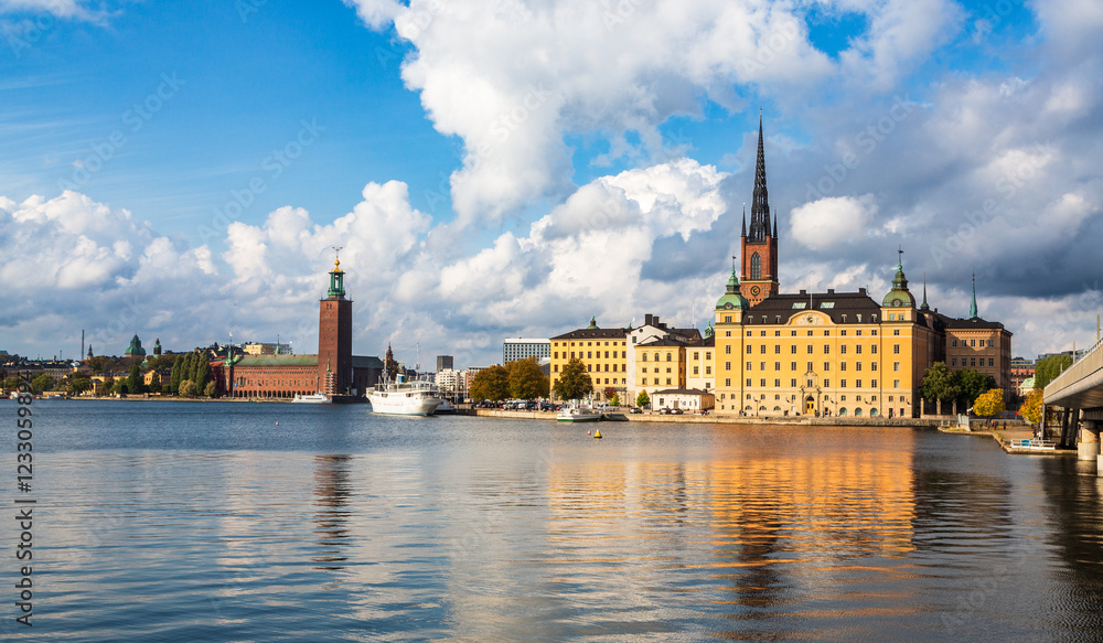 Fototapeta premium Stockholm, Sweden - 1 October 2022: Gamla Stan, old town in Stockholm at sunset with Riddarholmskyrkan church 