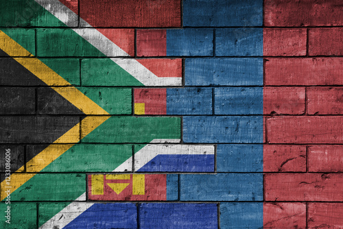 colourful painted big flag of south africa and flag of mongolia on a massive old brick wall background. concept photo