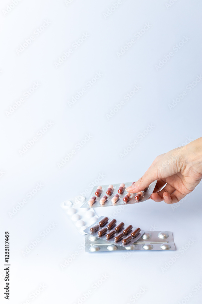 on white background on an outstretched female hand a silver blister with colored capsules suicidal thoughts depression health care pills in the air medical care others on the table on white background on an outstretched female hand a silver blister with colored capsules suicidal thoughts depression health care pills in the air medical care others on the table