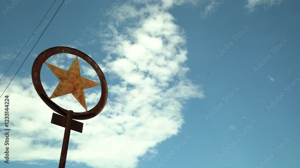 Old Rusty Metal Sign With Star Near Power Lines With Cloudy Blue Sky Close Up Zoom In Old Rusty Metal Sign With Star Near Power Lines With Cloudy Blue Sky Close Up Zoom In