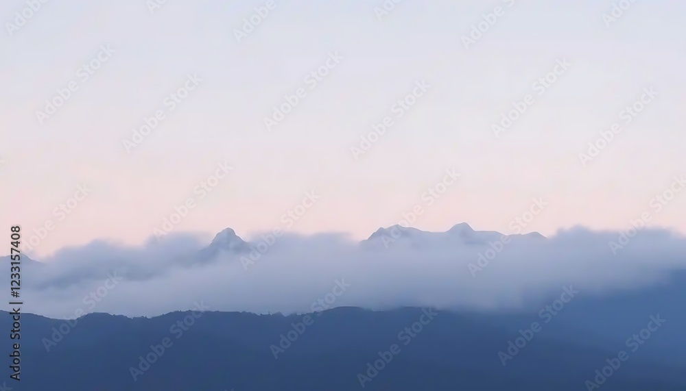 Fototapeta premium Misty Mountains Under a Pale Sky at Dawn