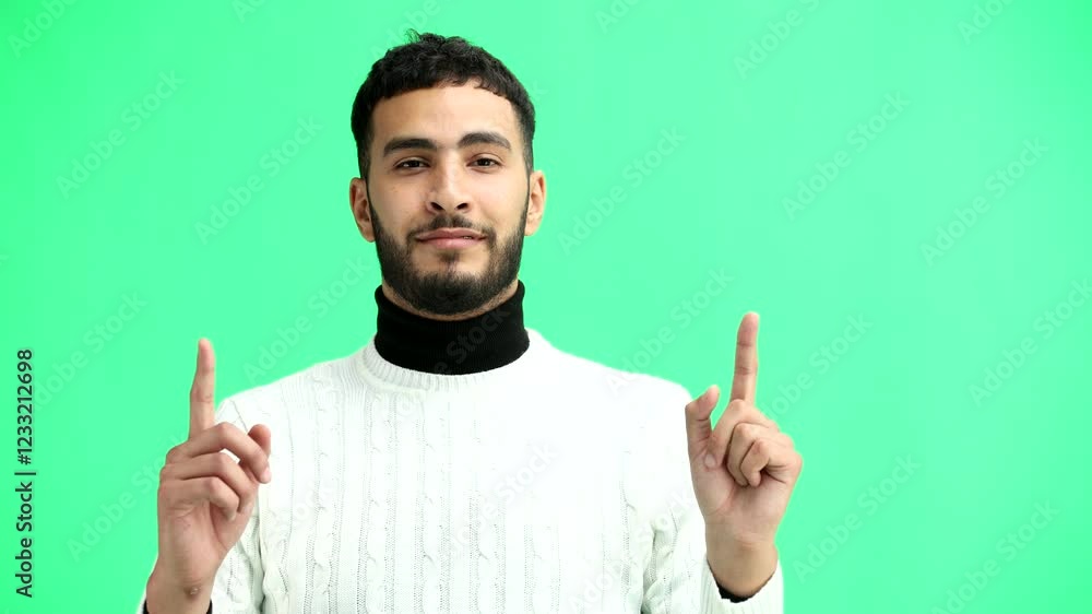 Man, close-up, on a green background, pointing up Man, close-up, on a green background, pointing up
