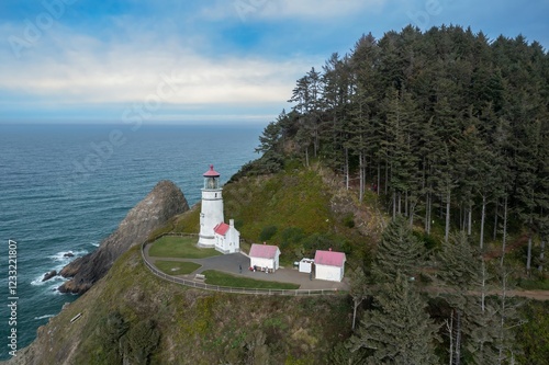 Aerial view of Heceta Head Lighthouse, Oregon, showcasing the iconic lighthouse, coastal scenery, and a secluded beach. Visitors enjoy the scenic beauty. ,Florence, Oregon, USA photo