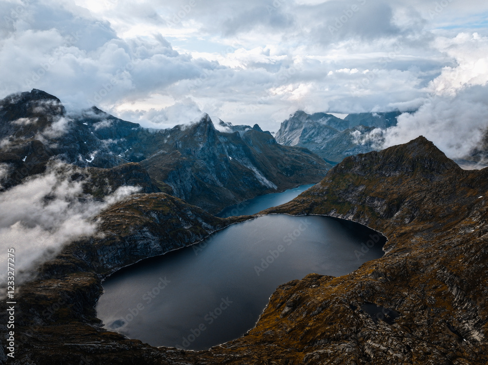 Experience breathtaking aerial views of a serene, pristine mountain lake landscape Experience breathtaking aerial views of a serene, pristine mountain lake landscape