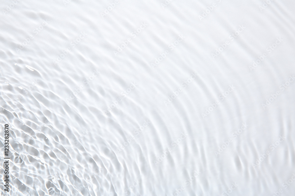 Obraz premium Rippled surface of clear water on white background, top view