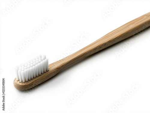 A pristine white bamboo toothbrush elegantly displayed on a spotless white backdrop. photo