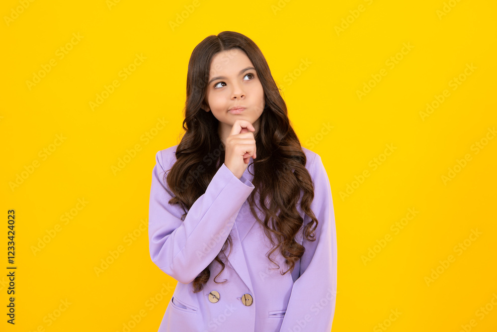 Thinking pensive clever teenager girl. Thoughtful teenager girl touch chin and thinking, pensive child making idea, posing isolated on yellow studio background. Thinking pensive clever teenager girl. Thoughtful teenager girl touch chin and thinking, pensive child making idea, posing isolated on yellow studio background.
