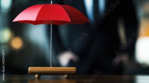 Red Umbrella on a Wooden Base in Front of a Businessman in a Formal Setting
