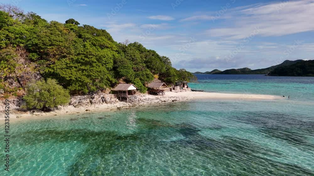 Aerial drone view of Coron Island’s dramatic cliffs, tropical greenery, and idyllic turquoise waters, Philippines. Revealing shot starting on bungalows and ascending. Aerial drone view of Coron Island’s dramatic cliffs, tropical greenery, and idyllic turquoise waters, Philippines. Revealing shot starting on bungalows and ascending.