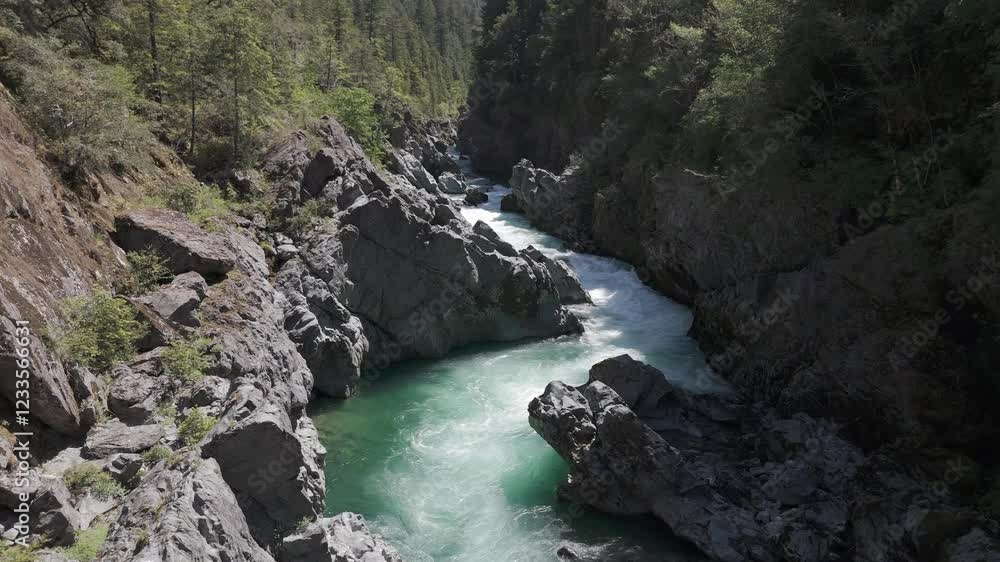 Drone-slow and low three quarter down angle flying shot along an s-turn with white water on the Smith River in California Drone-slow and low three quarter down angle flying shot along an s-turn with white water on the Smith River in California
