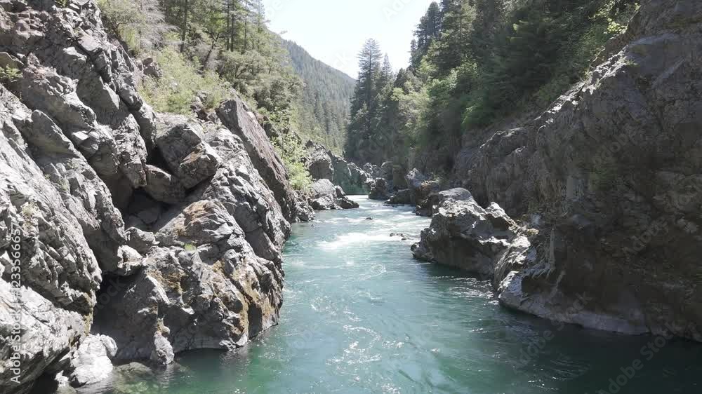 Drone-slow and low flying shot along a rock canyon on the Smith River in California Drone-slow and low flying shot along a rock canyon on the Smith River in California