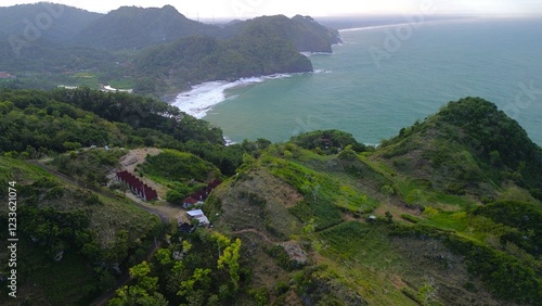 Bird eye view View of the coastline with hills and trees, cliffs, coral reefs and waves from the sea at Surumanis Beach, Kebumen, Central Java photo