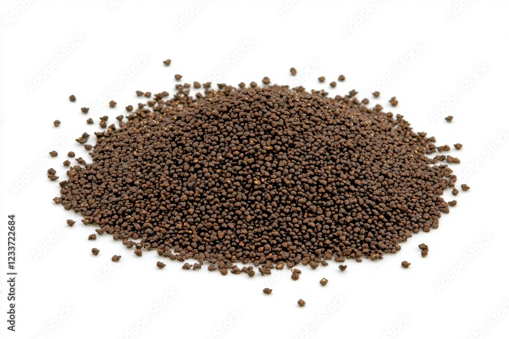 Black seeds spread across a white surface showcasing texture and detail of these tiny grains Black seeds spread across a white surface showcasing texture and detail of these tiny grains