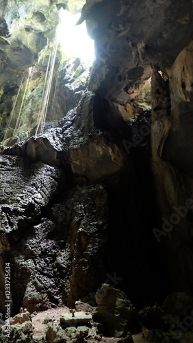 A cave with light shining through.