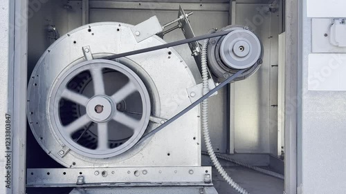 HVAC motor of air conditioning running with the belt on the rooftop of the restaurant in the US.