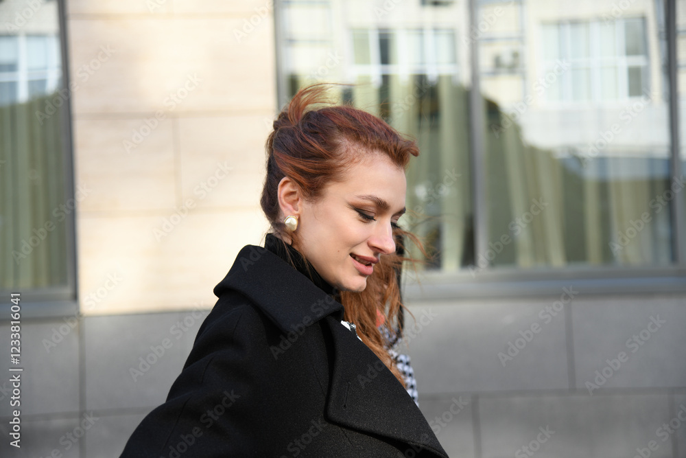 Woman walking on the street during autumn in a city setting Woman walking on the street during autumn in a city setting