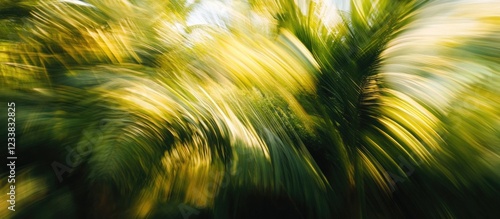Abstract motion blur of green palm leaves in sunlight