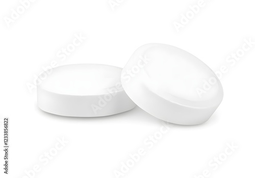 White tablet on a white background, isolated on a transparent or clean white background with a clipping path. The pill is round and has no label. Close-up view of two pills, one lying down and 