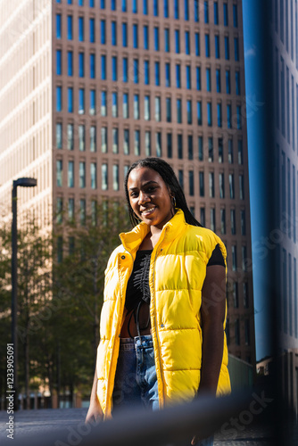 Portrait, smile or black woman looking at camera, rendy or confident model on street city background. African person, face or happy girl with casual clothing, fashion or cheerful with stylish outfit photo