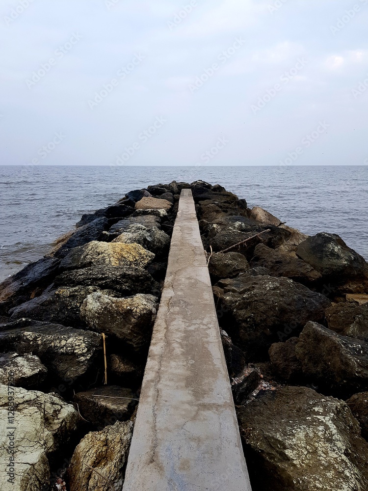 concrete pier in the sea, closeup photo with selective focus concrete pier in the sea, closeup photo with selective focus
