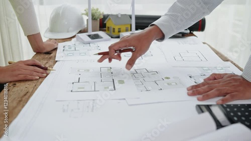 Close up of hands working brainstorming and measuring for cost estimating on paperworks and floor plan drawings about design architectural and engineering for houses and buildings.