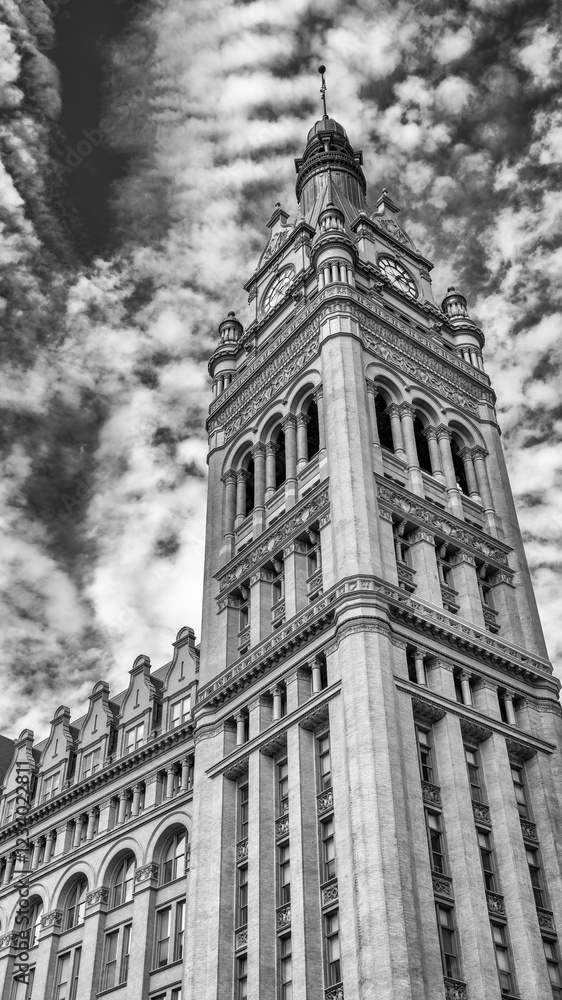 Milwaukee City Hall clock tower standing tall with historic architecture and blue sky Milwaukee City Hall clock tower standing tall with historic architecture and blue sky