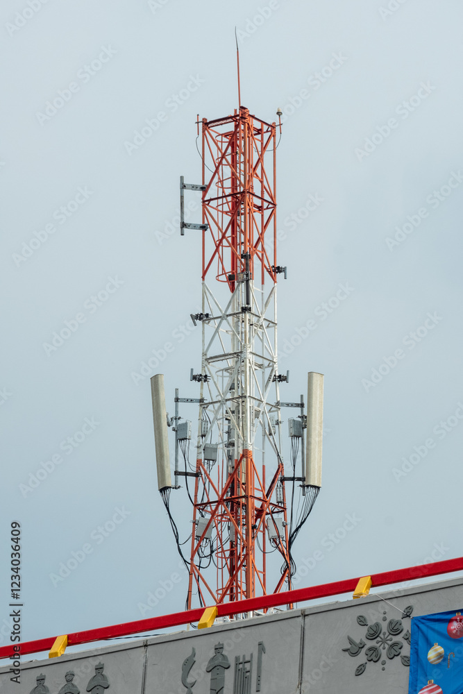 red and white electric transmission tower with blue sky background red and white electric transmission tower with blue sky background