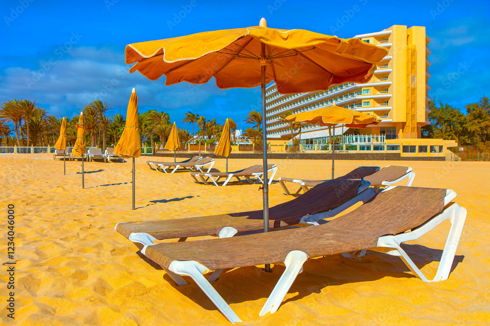 Sandy beach with sun loungers and umbrellas set