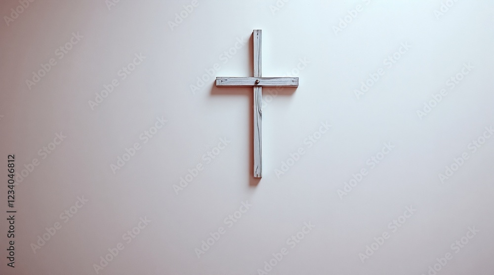White cross on light pink wall in minimalist setting White cross on light pink wall in minimalist setting