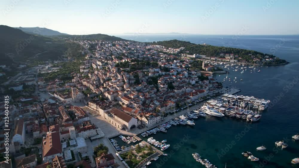 Pan drone shot over Hvar city center and port with sunny weather in the day in Croatia Pan drone shot over Hvar city center and port with sunny weather in the day in Croatia