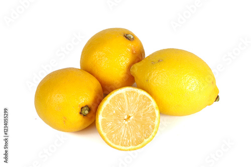 A whole lemon and a halved lemon placed on a white background