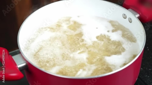 Pasta boiling in pot on stove Close view