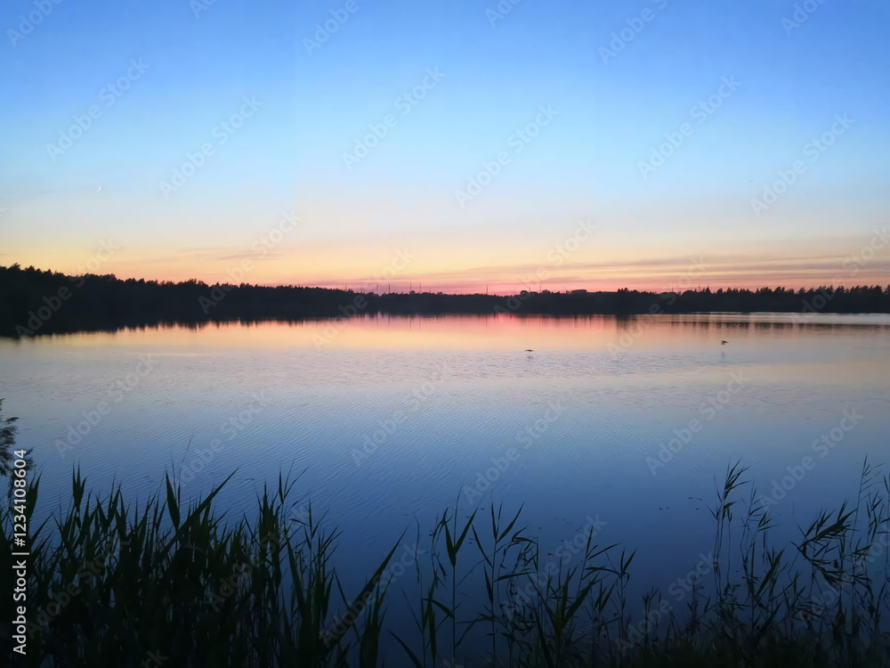 Fototapeta premium Scenic breathtaking tranquil pond at sunset with calm colorful sky reflection.