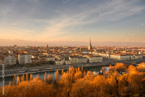 Fototapeta Naklejka Na Ścianę i Meble -  Panoramic view on the autumn city of Turin (Torino) during sunset. Mole Antonellia, Po river and Alps mountains on background. Piedmont, Italy