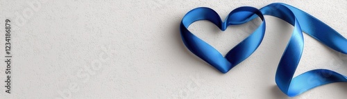 Blue Ribbon Shaped Into Heart Resting on Light Background for Creative Projects and Designs