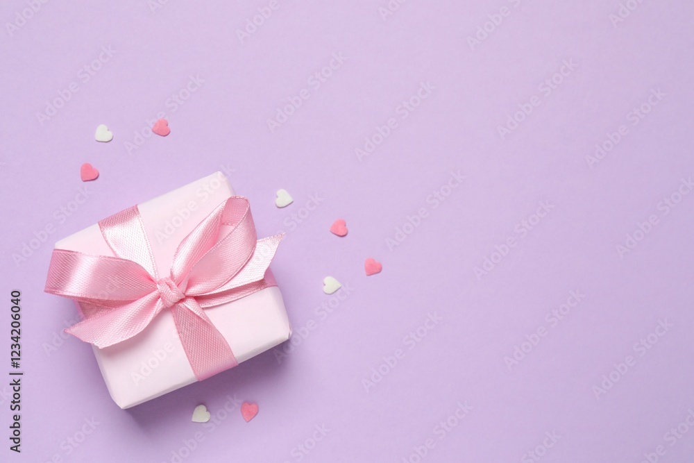 Beautiful gift box with pink hearts on color background Beautiful gift box with pink hearts on color background