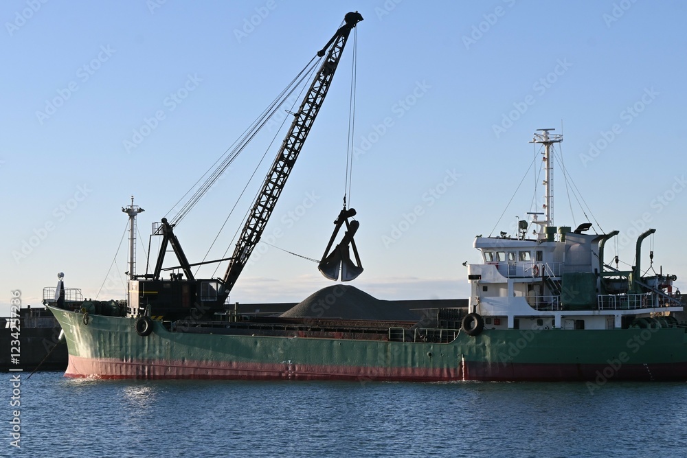 A scene of dredging work at the port. The purpose of dredging work is to scoop up sediment from the seabed with a dredger ship to ensure safe navigation of ships. A scene of dredging work at the port. The purpose of dredging work is to scoop up sediment from the seabed with a dredger ship to ensure safe navigation of ships.