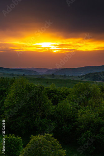 Obraz na płótnie Aerial view of the lush green hills of Transylvania during sunset, showcasing the natural beauty and untouched landscapes of this Romanian region. Travel to Romania. w salonie