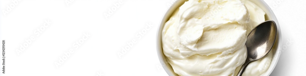 A bowl of whipped cream served with a spoon, perfect for desserts or toppings A bowl of whipped cream served with a spoon, perfect for desserts or toppings