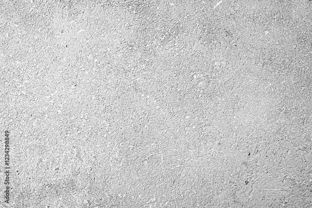 Obraz premium Close-up of a rough gray concrete surface with a fine, textured pattern. Perfect for backgrounds or design use.