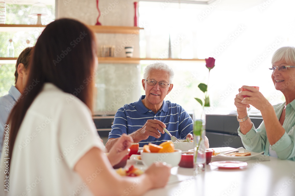 Home, family and conversation with food for breakfast, eating and bonding together in morning. Kitchen, senior parents and people with nutrition for wellness, communication and connection with smile Home, family and conversation with food for breakfast, eating and bonding together in morning. Kitchen, senior parents and people with nutrition for wellness, communication and connection with smile