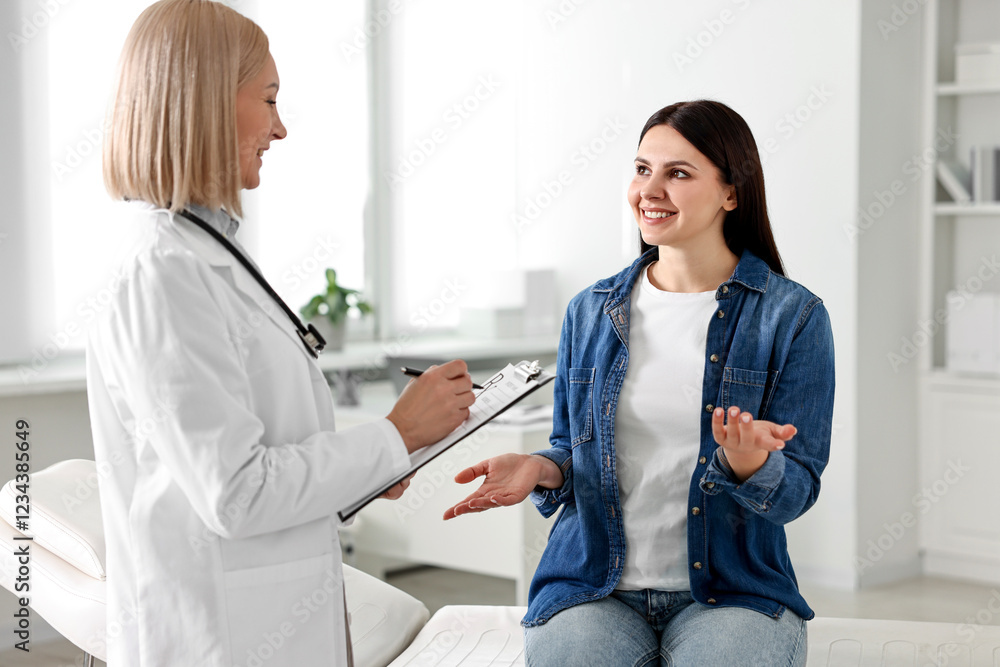 Fototapeta premium Woman having appointment with doctor in hospital