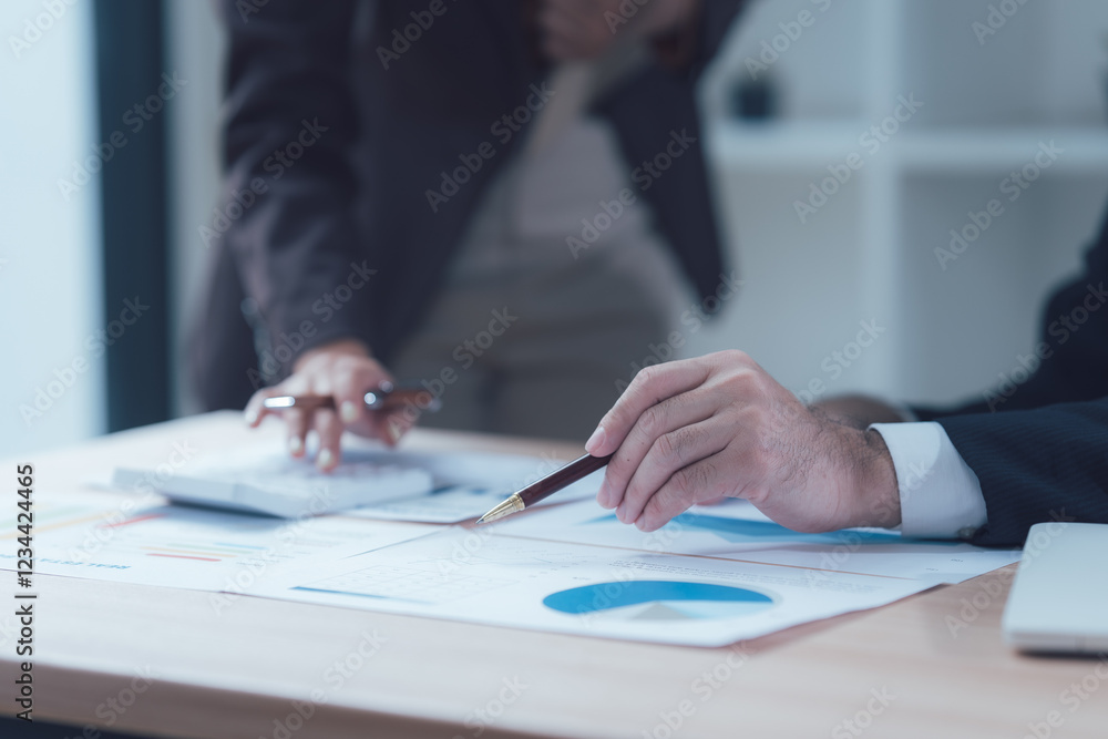 Strategic Analysis: A close-up shot of business professionals meticulously analyzing financial data, showcasing their dedication and focus in a modern office setting. Strategic Analysis: A close-up shot of business professionals meticulously analyzing financial data, showcasing their dedication and focus in a modern office setting.